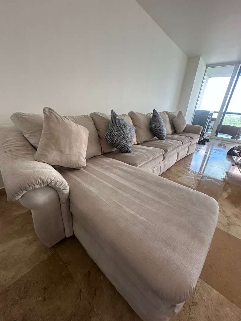 Real beige sectional sofa in a Miami high-rise interior